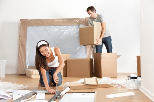 Removal team loading household items into a van