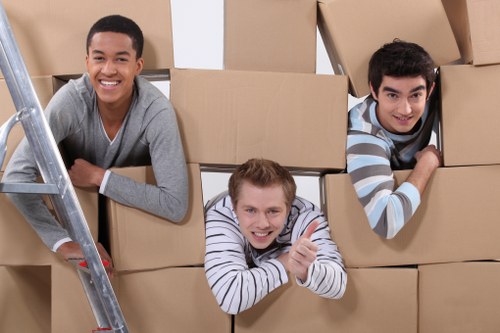 Removal team handling furniture and boxes at a Hounslow property