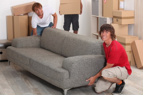 Staff arranging office desks and furniture in a new workspace