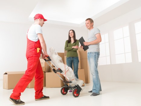 Experienced moving team handling packed boxes with care